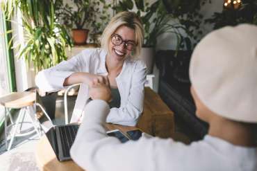 cheerful women have agreement with startup project